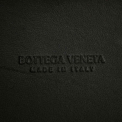 Black leather bag interior label text embossed on fabric surface