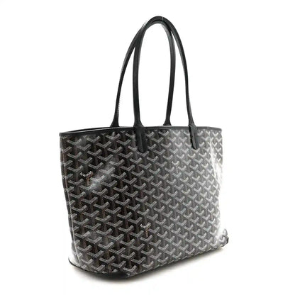 Goyardine PM tote bag in dark canvas with black leather handles.
