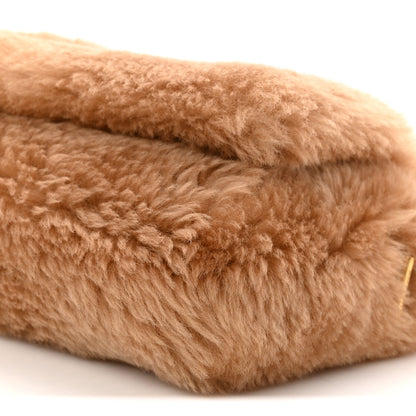 Saint Laurent shearling satchel corner with light brown curly pile texture close-up
