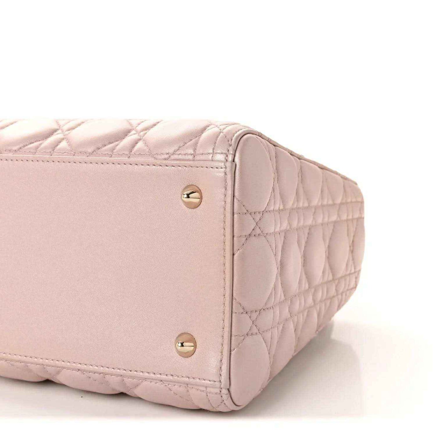 Light pink quilted handbag end with gold studs and rounded structured shape