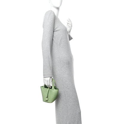 Green mini handbag worn on the shoulder with a short chain strap