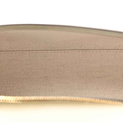 Zipper trim and light inner lining detail on a green leather handbag