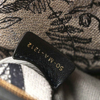 Christian Dior dark leather patch label on embroidered fabric