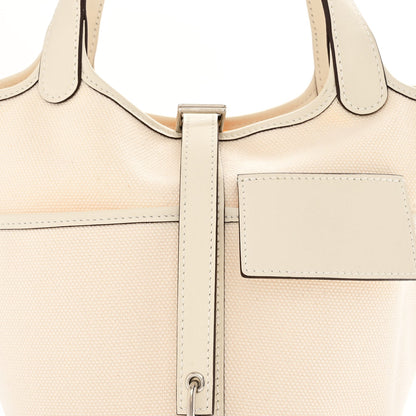 Nata canvas tote with top handles, front pocket, and center zipper hardware