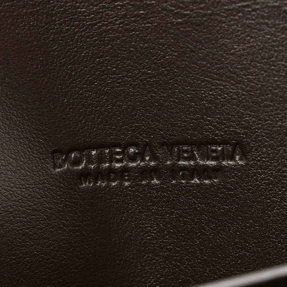 Bottega Veneta embossed leather clutch exterior in dark tone