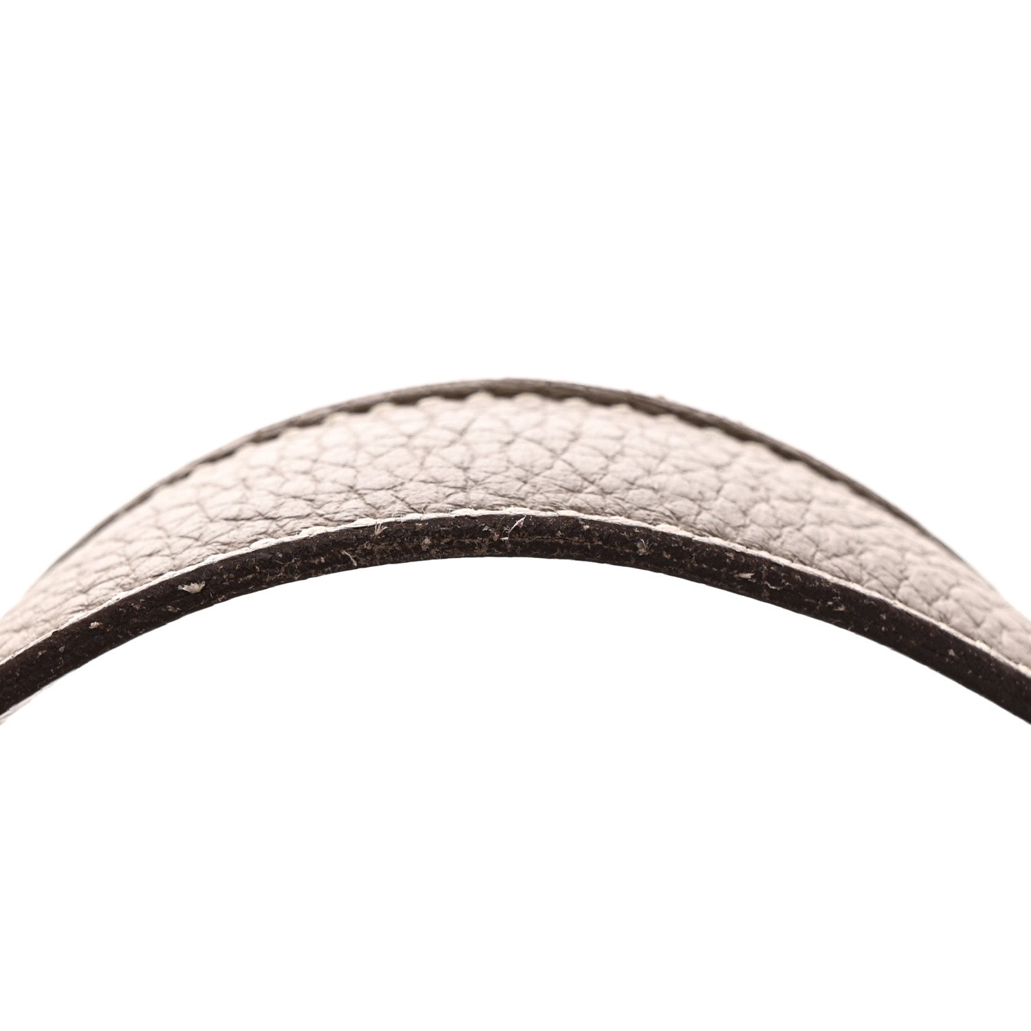 Taupe calfskin leather bag handle close-up, textured grain and dark trim