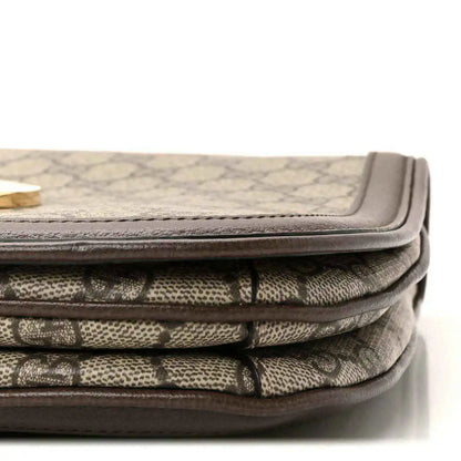 Stacked beige GG monogram canvas with brown leather edging and flap seam detail