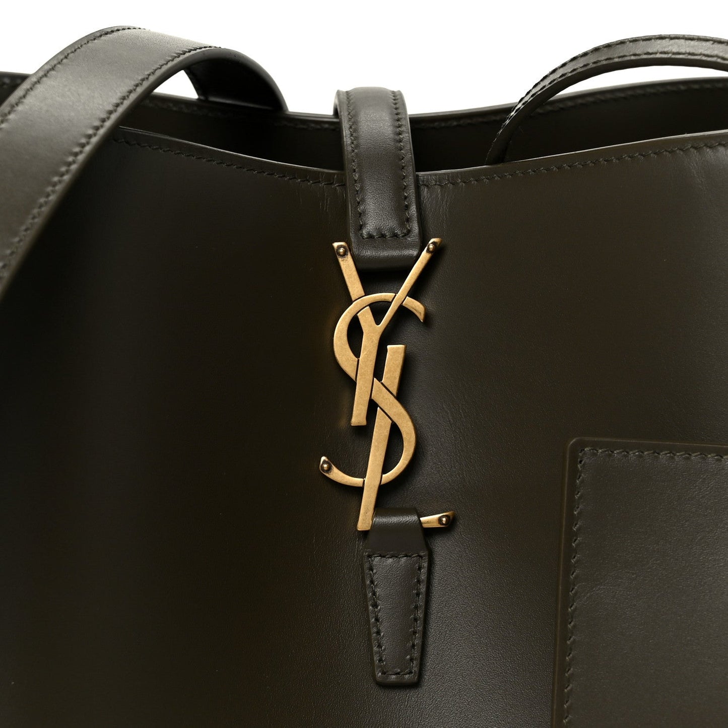 Saint Laurent YSL logo hardware on deep musk bucket bag front with leather strap tab.