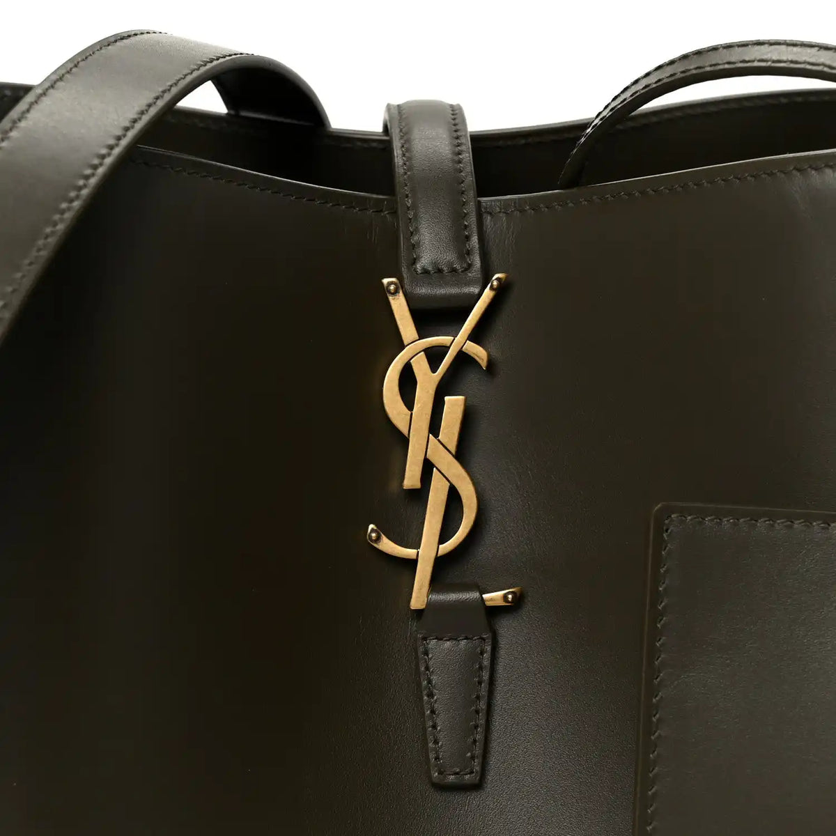 Saint Laurent YSL logo hardware on deep musk bucket bag front with leather strap tab.