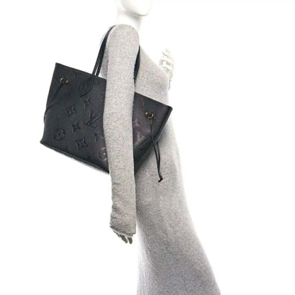 Neverfull MM tote bag, dark black embossed monogram leather, side profile and straps
