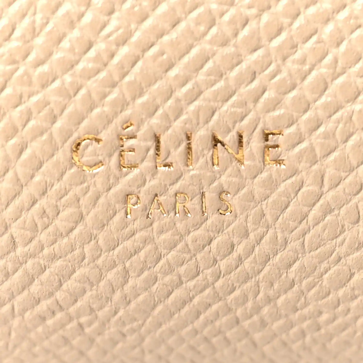 Celine stamp logo on light taupe grained leather, close-up