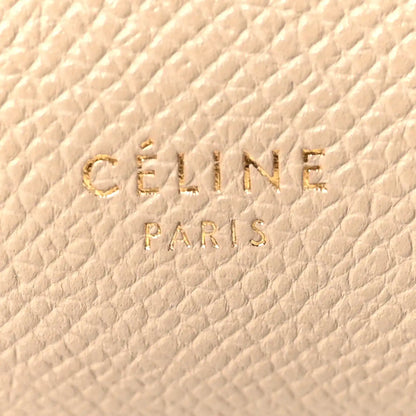 Celine stamp logo on light taupe grained leather, close-up
