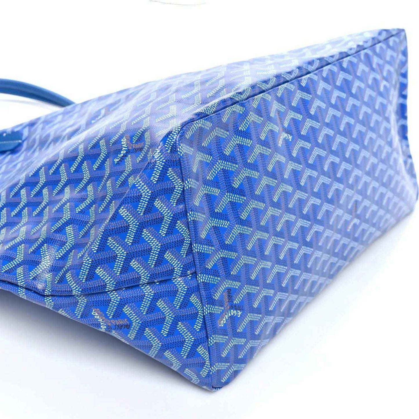 Sky blue Goyardine tote bag side view with woven pattern and structured base.