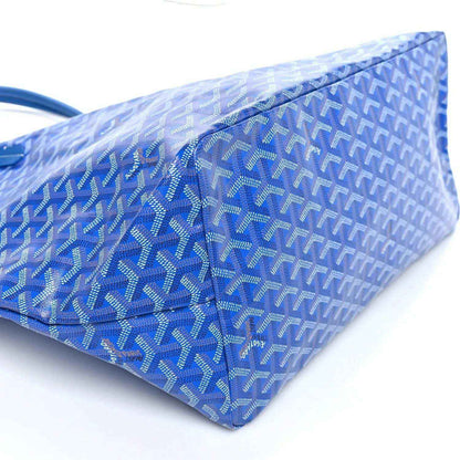 Sky blue Goyardine tote bag side view with woven pattern and structured base.