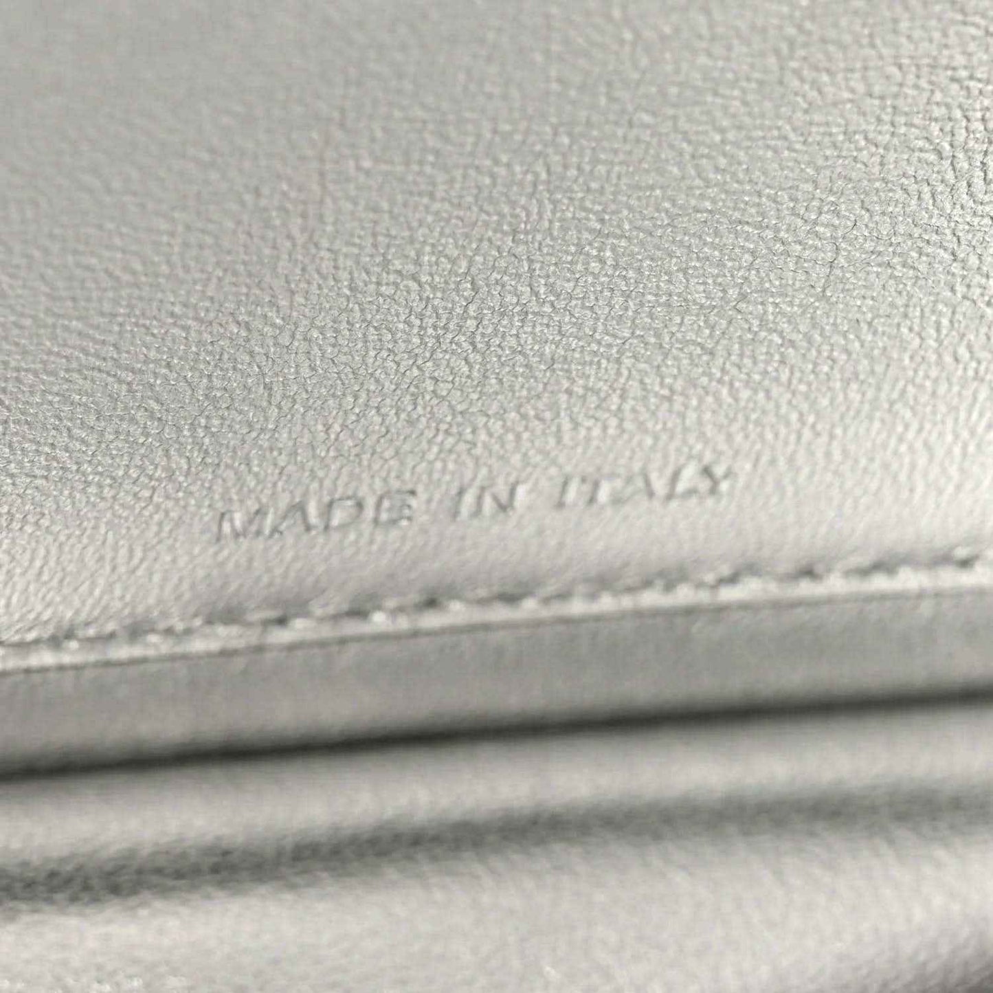 Light gray leather lining with faint stamped text near stitching