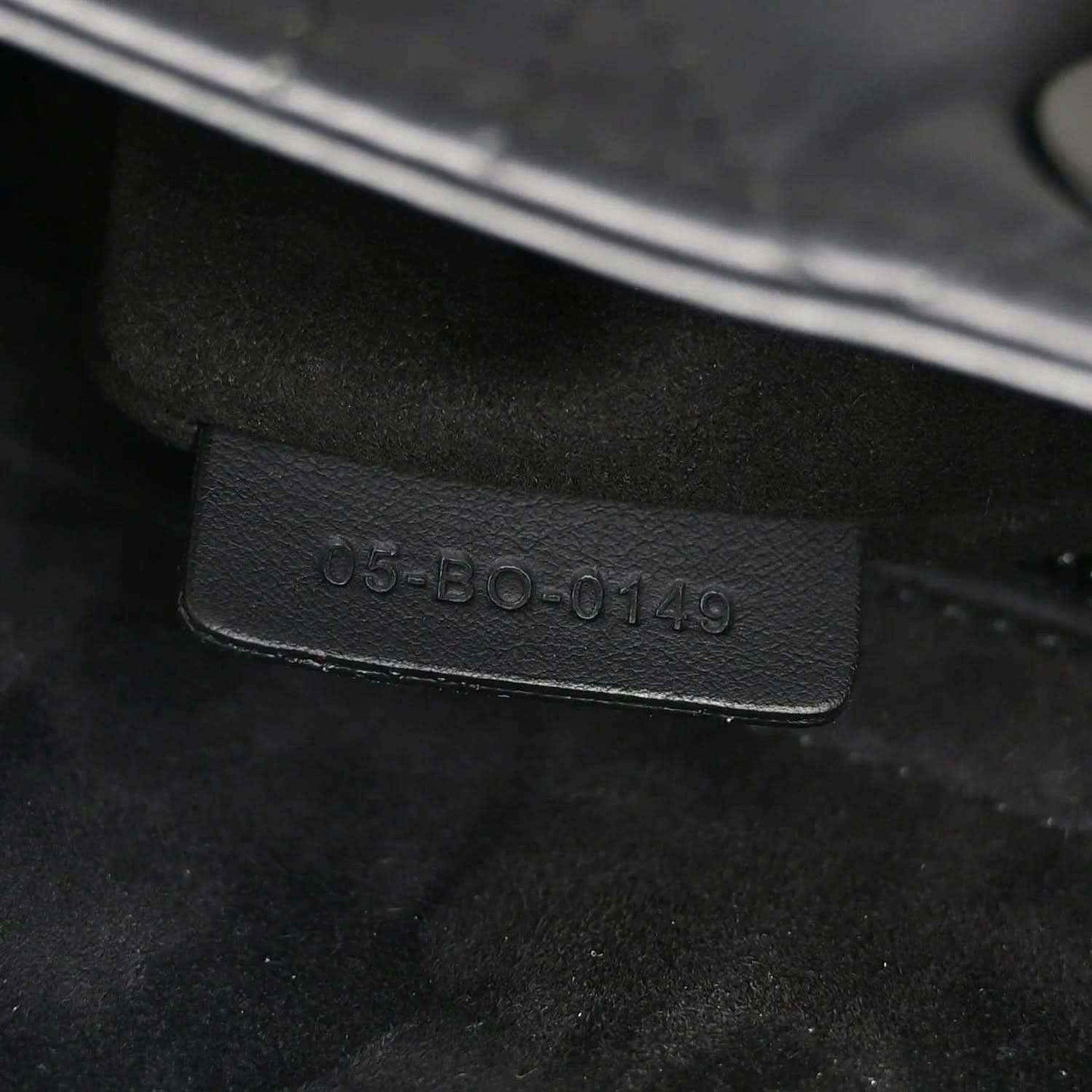 Black leather bag code embossing on interior tag, "05-B0-0149"