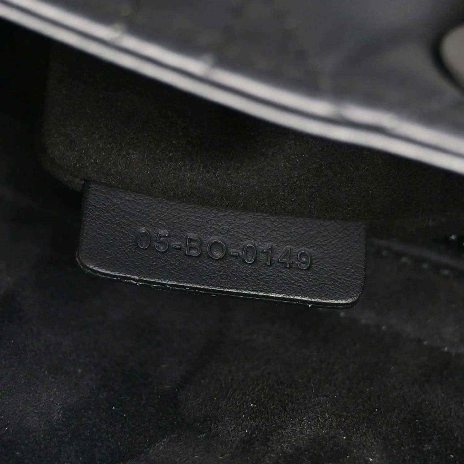 Black leather bag code embossing on interior tag, "05-B0-0149"