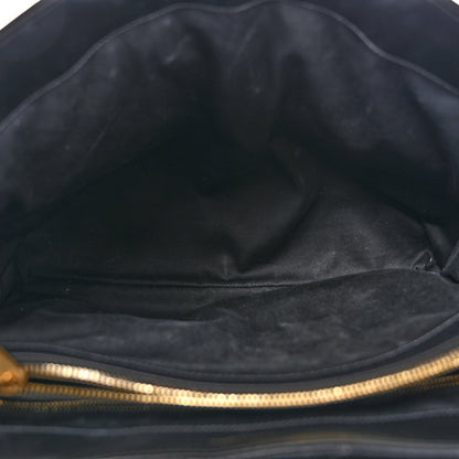 Black satchel interior with fabric lining and gold-tone zipper trim