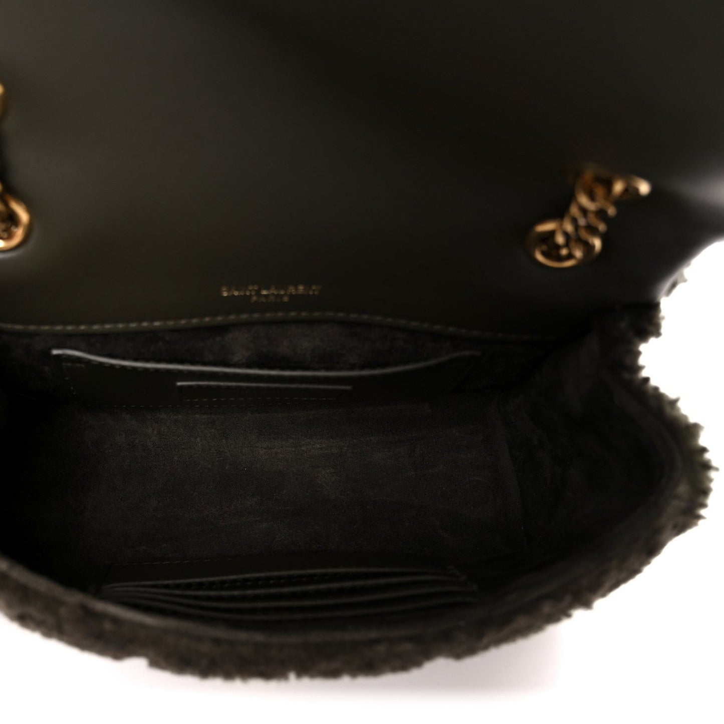 Dark shearling shoulder bag interior with leather lining and stitched pocket