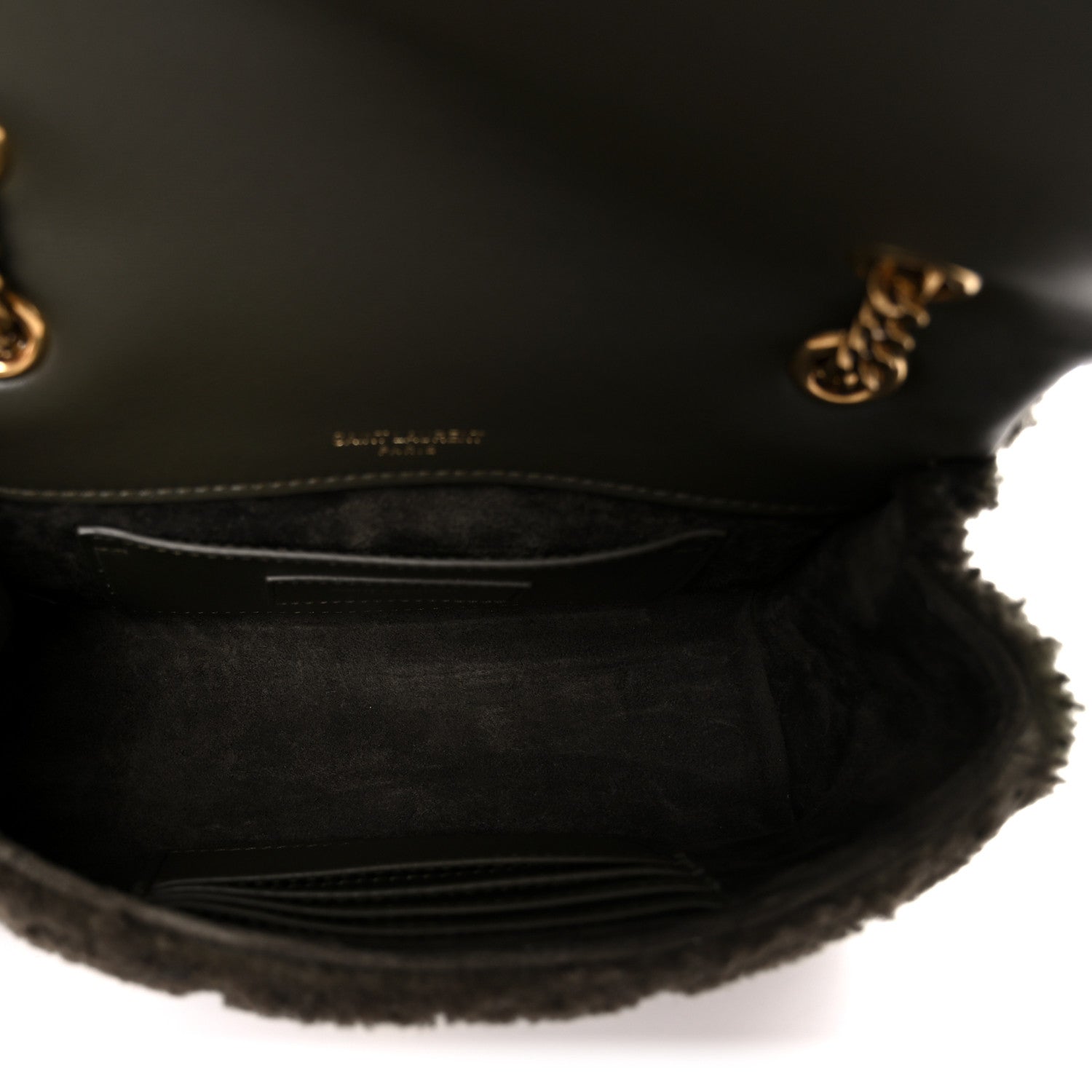 Dark shearling shoulder bag interior with leather lining and stitched pocket