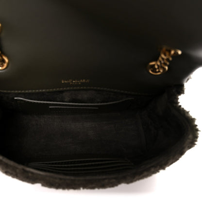 Dark shearling shoulder bag interior with leather lining and stitched pocket