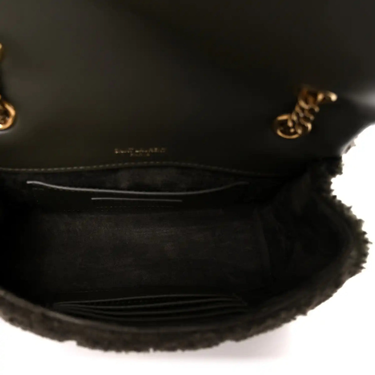 Dark shearling shoulder bag interior with leather lining and stitched pocket