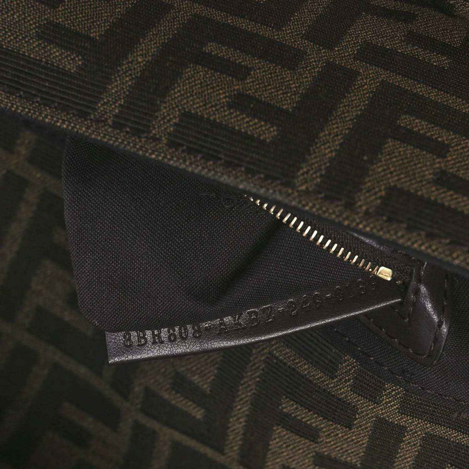 Fendi FF jacquard bag close-up of zipper and brand tab on dark brown fabric