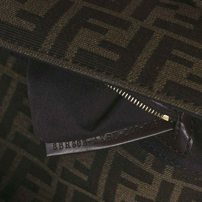 Fendi FF jacquard bag close-up of zipper and brand tab on dark brown fabric