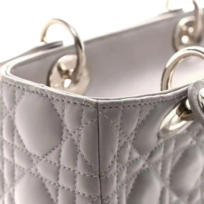 Grey quilted medium Lady Dior handbag corner with top handle loop and stitching
