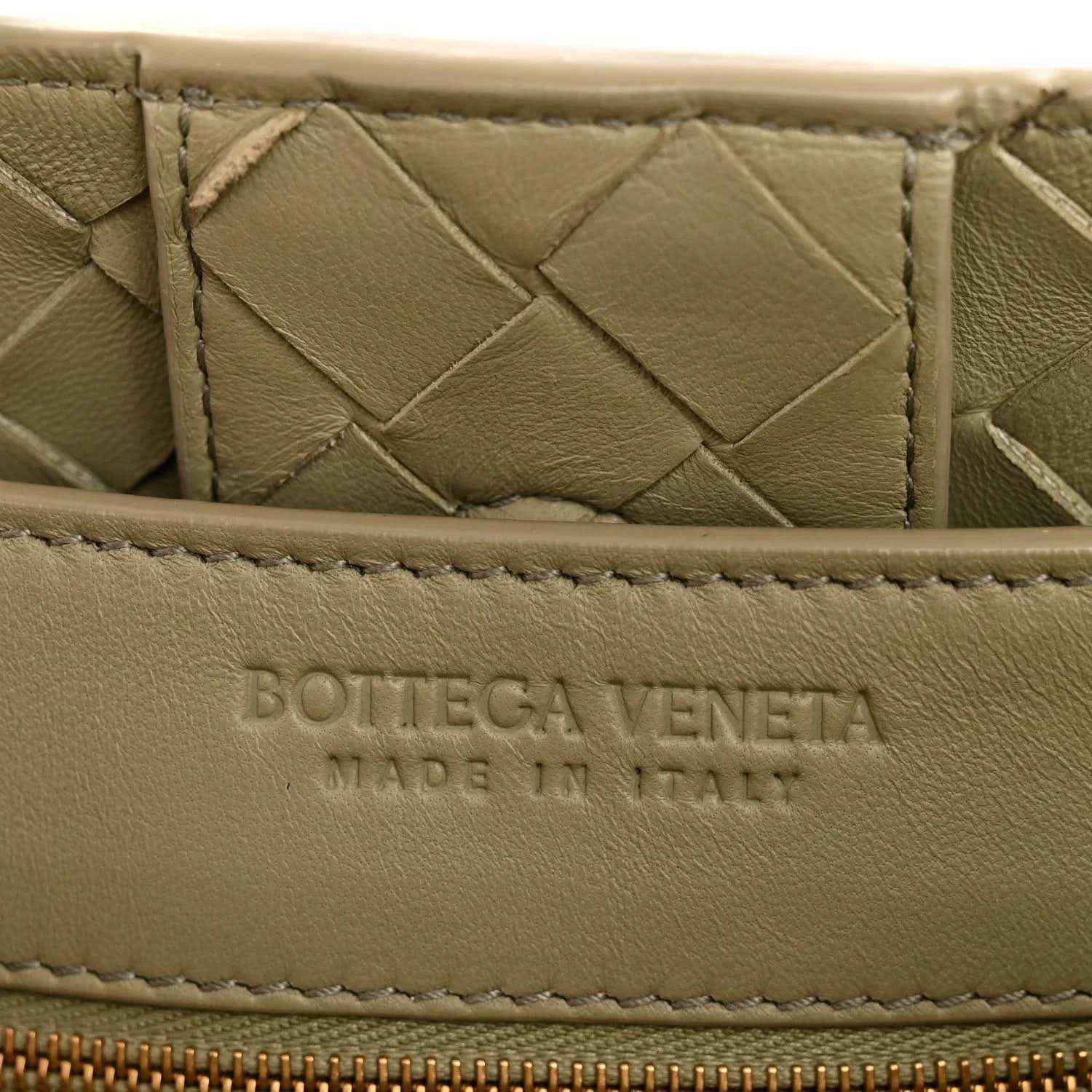 Leather interior panel with embossed logo, woven nappa texture in light tan