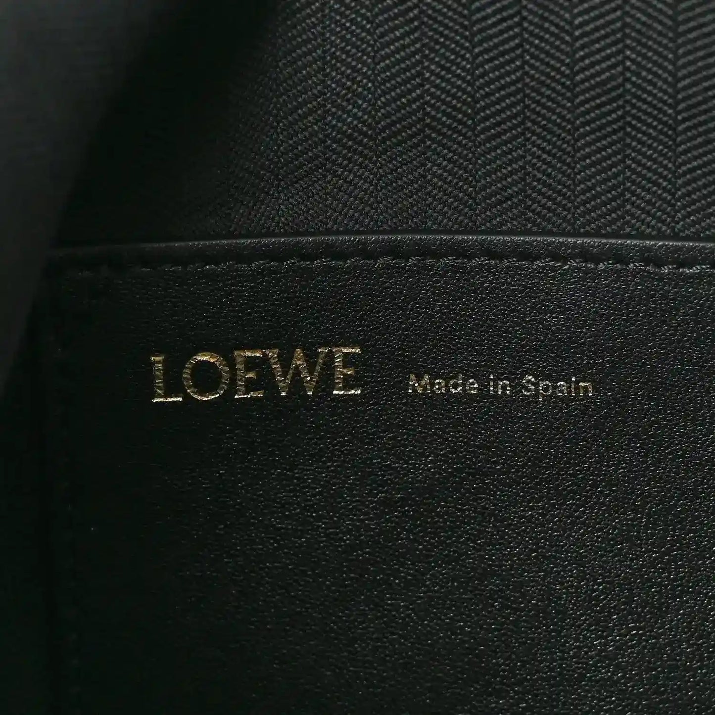 Black leather interior label with LOEWE and Made in Spain text