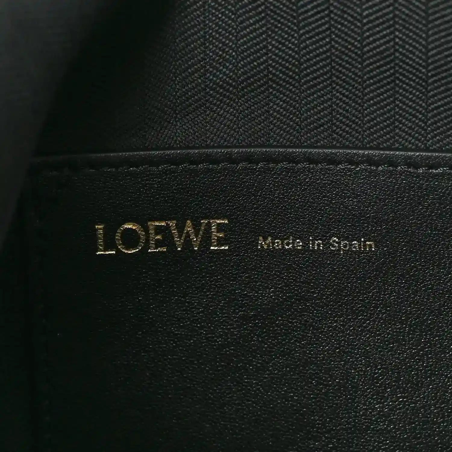 Black leather interior label with LOEWE and Made in Spain text