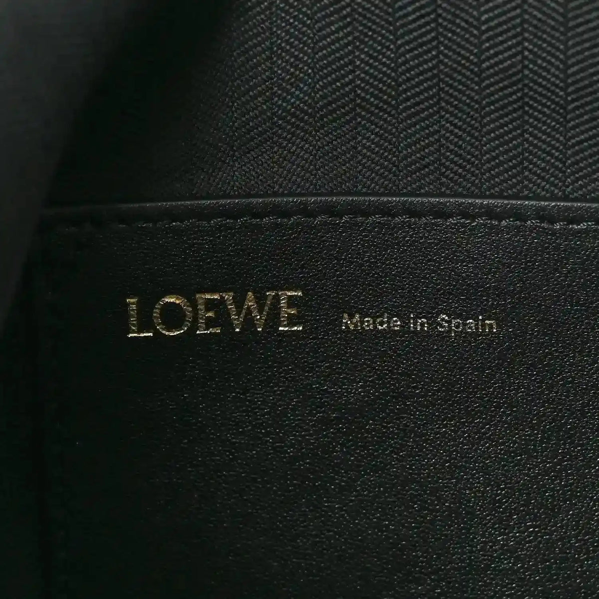 Black leather interior label with LOEWE and Made in Spain text
