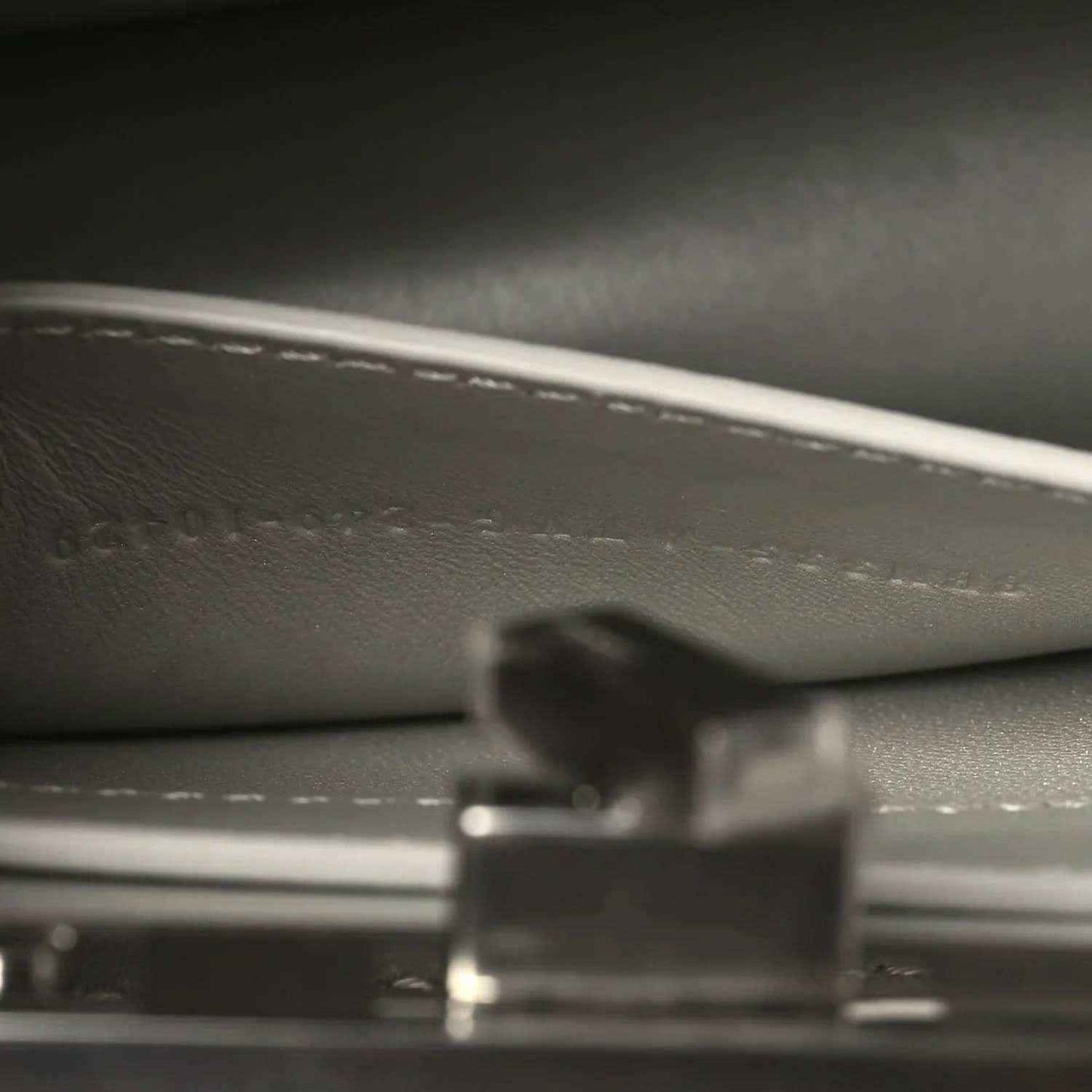 Small satchel interior close-up showing lining texture and metal hardware