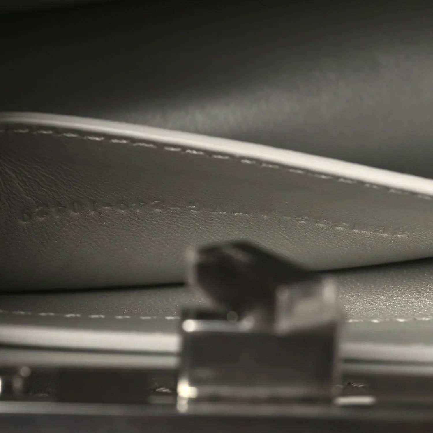 Small satchel interior close-up showing lining texture and metal hardware