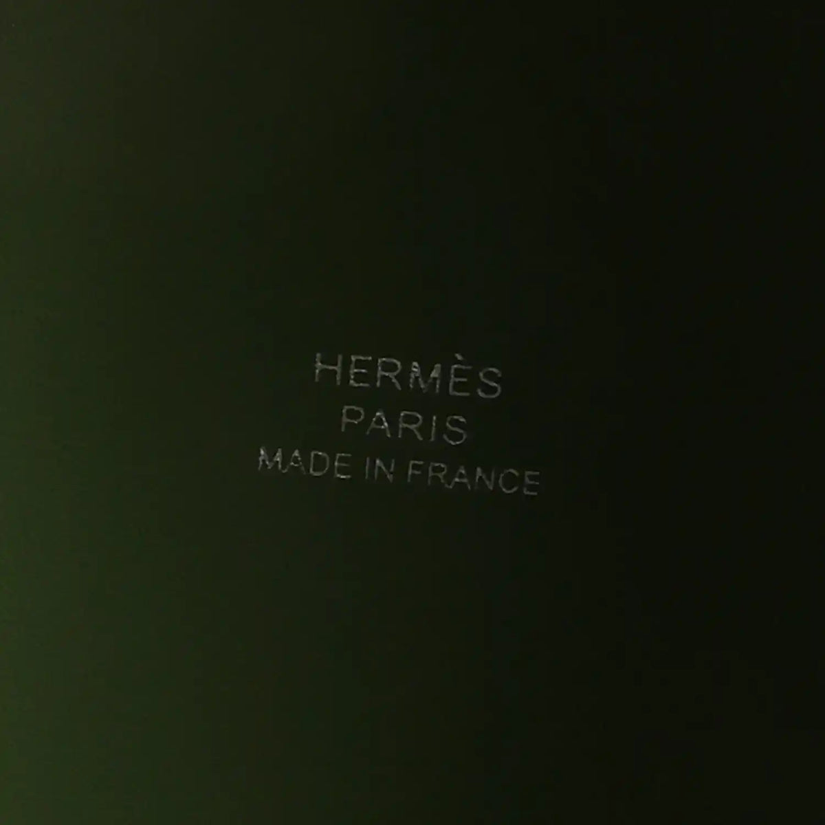 Green leather interior with embossed text reading PARIS and MADE IN FRANCE
