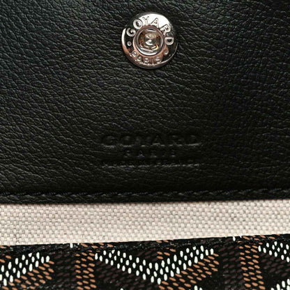 Goyard logo button and embossed leather patch on black tote bag