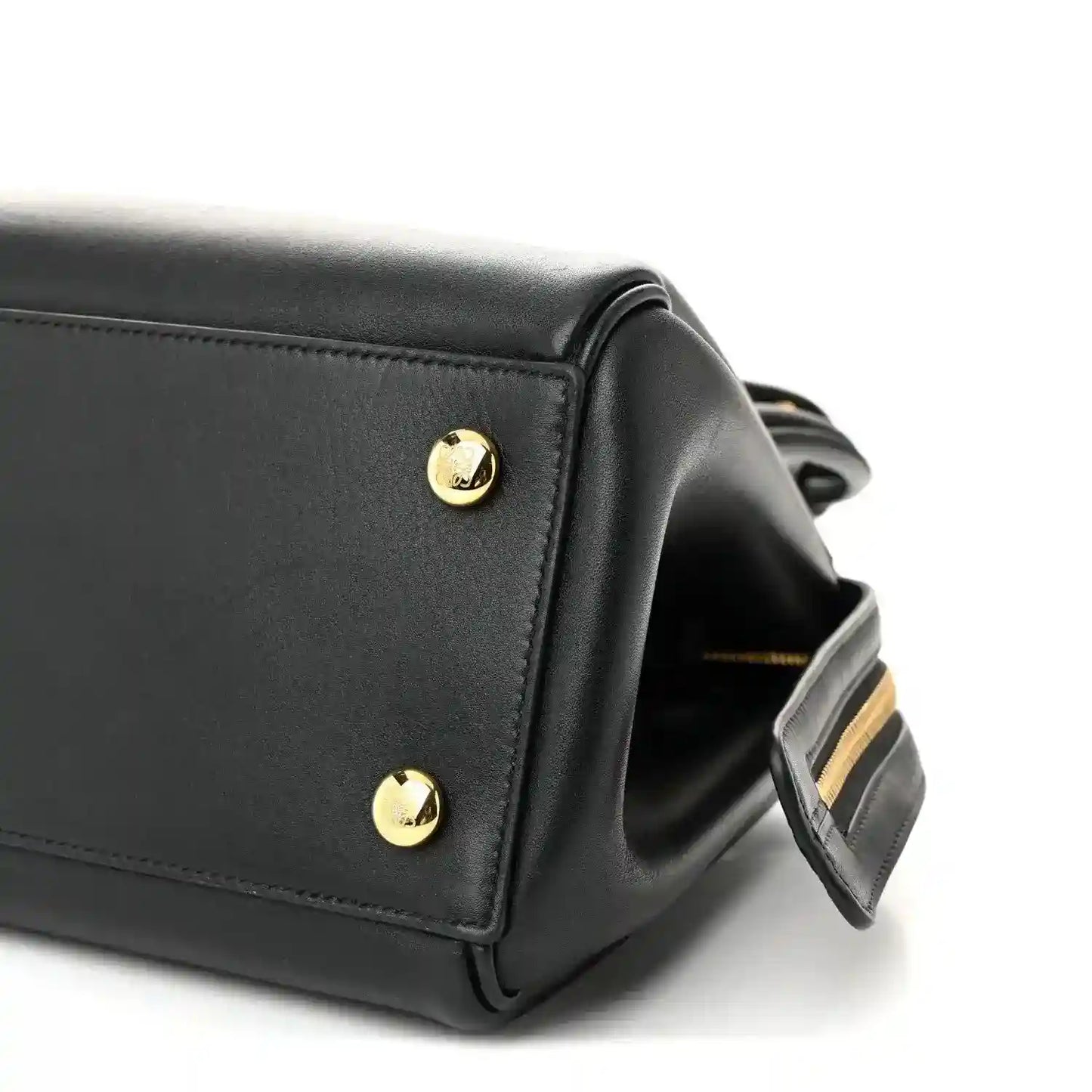 Black Small Madrid bag corner with gold stud and attached shoulder strap detail.
