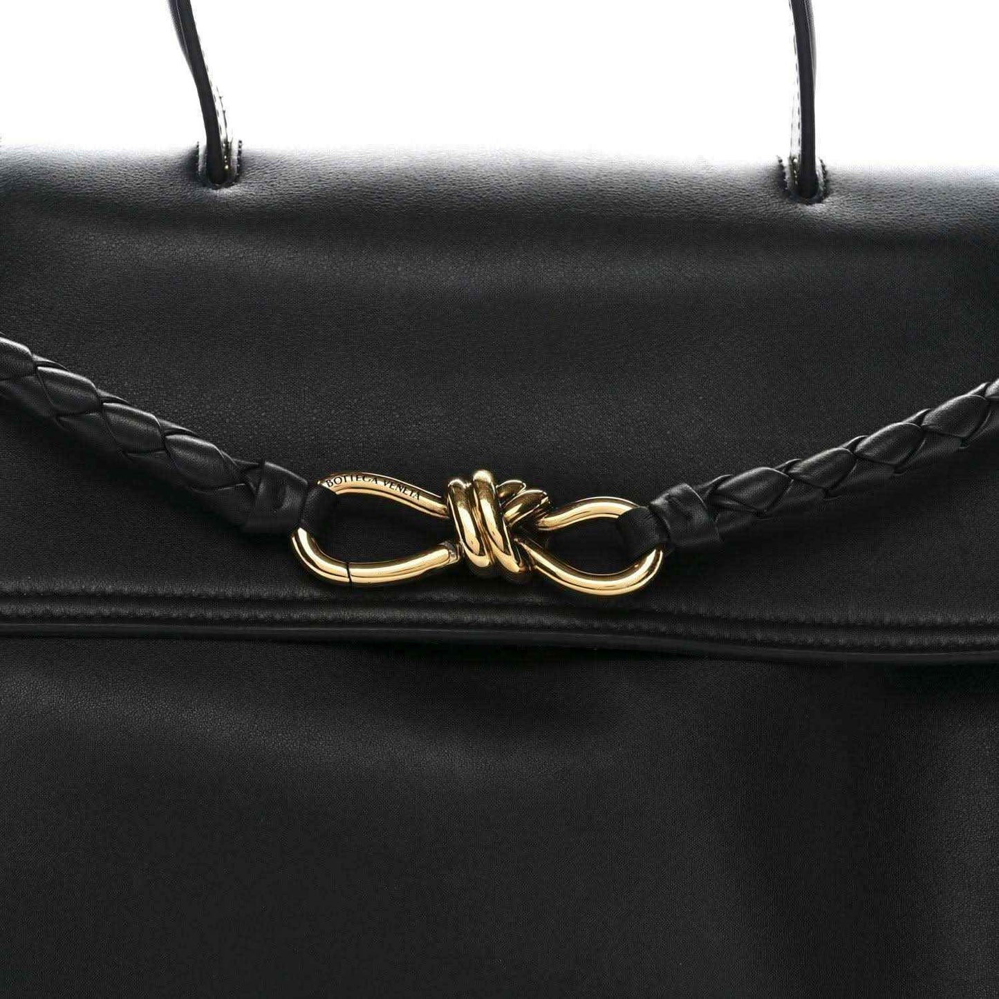 Black leather Ciao Ciao shoulder bag front clasp detail with braided cords and gold hardware.