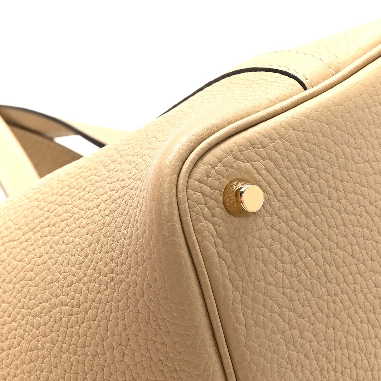 Beige leather tote side tab with round snap button hardware