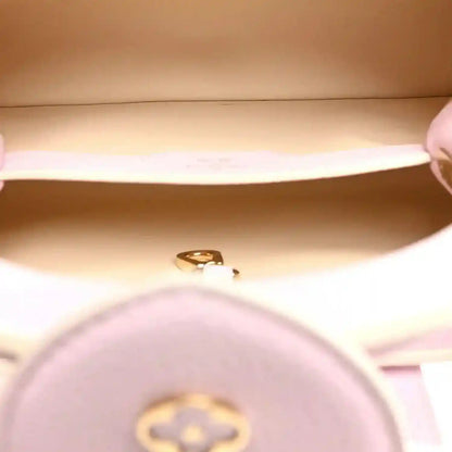 Pink leather handbag interior with gold clasp hardware close-up