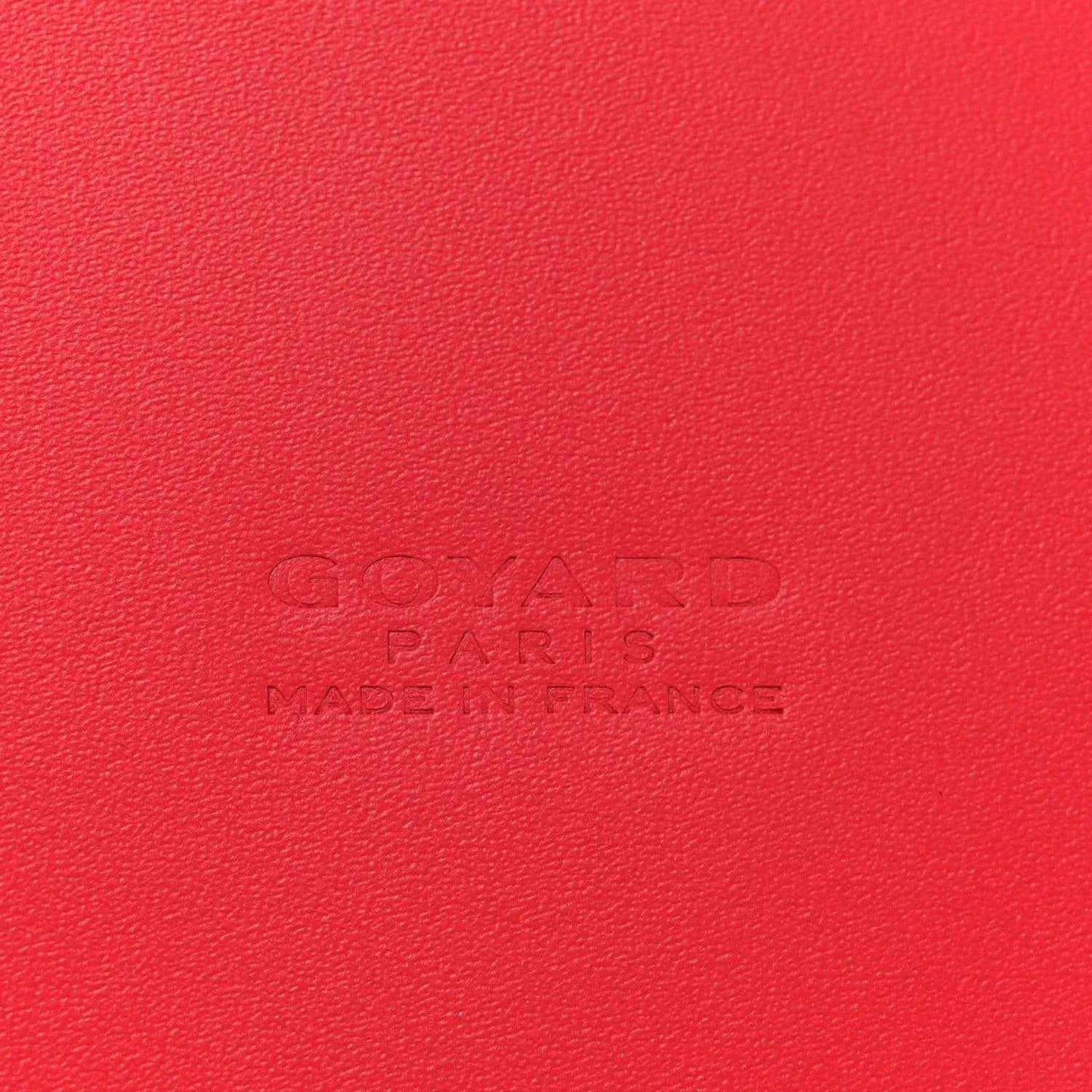 Red leather handbag panel with embossed Goyard Paris branding