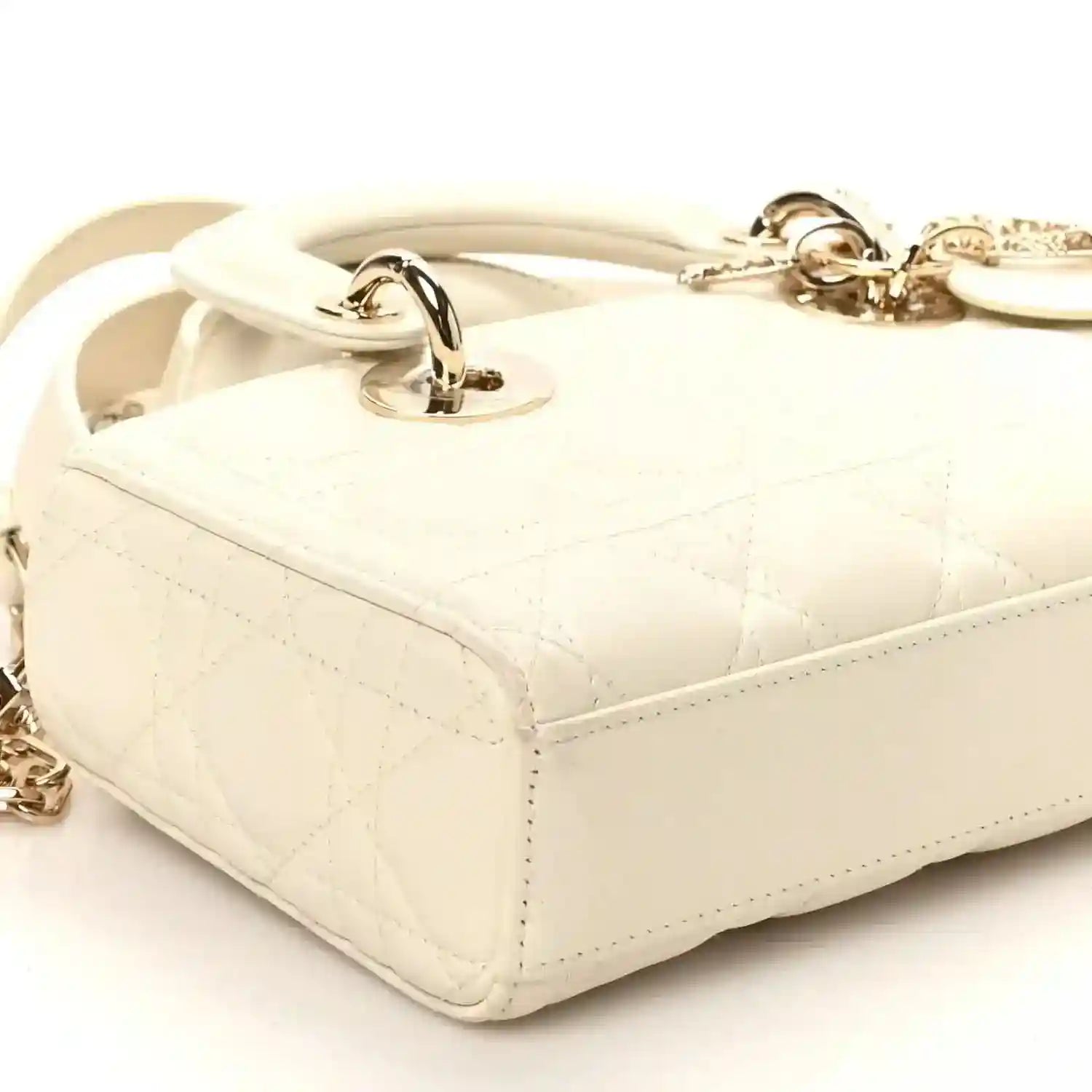 Small white quilted handbag with side handle rings and gold-tone latch