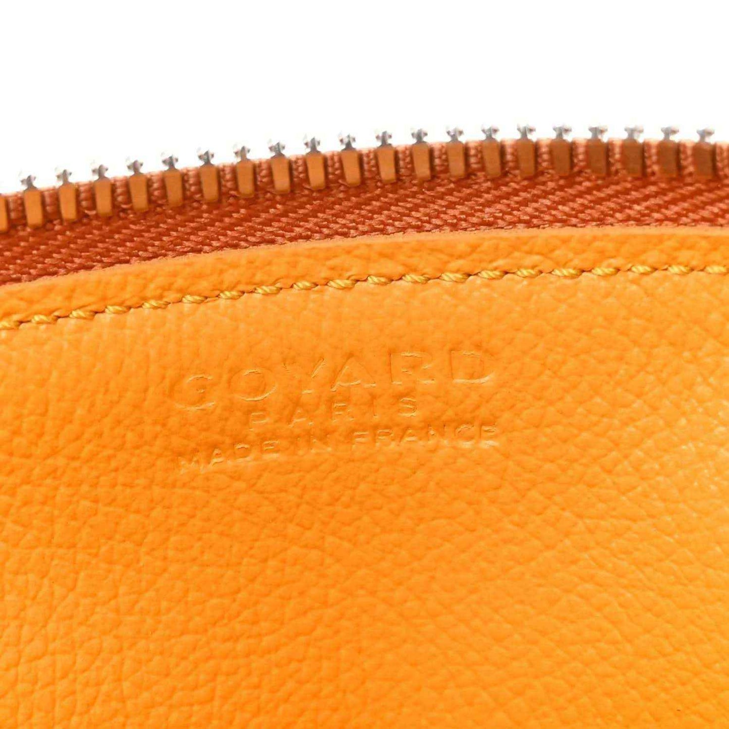 Orange leather top trim detail with embossed Goyardine logo and braided stitch line