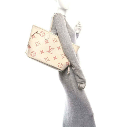 Louis Vuitton Neverfull MM tote bag angled view, rose monogram on creme, includes strap