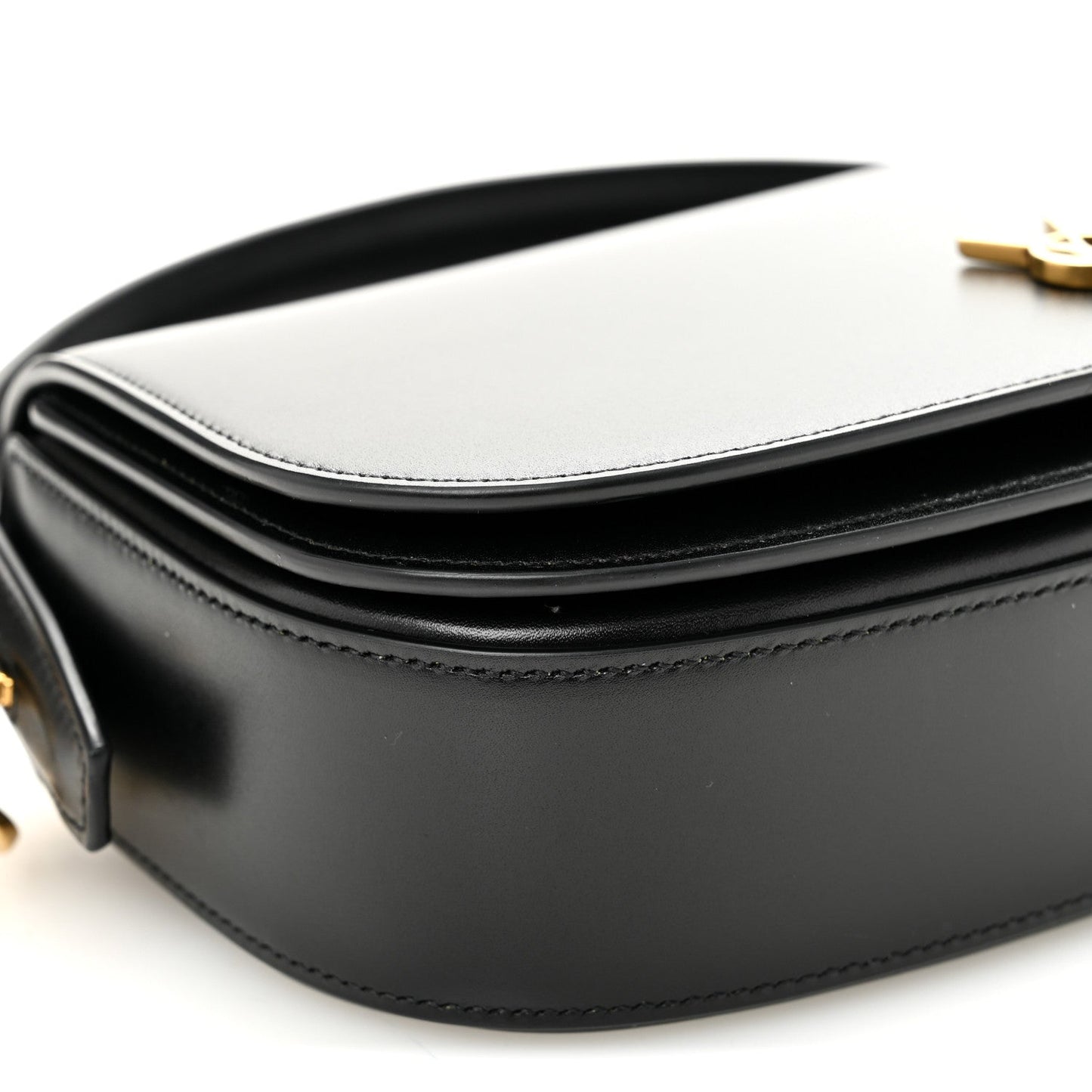 Bicolor leather crossbody bag detail with white flap, black body, and YSL clasp.