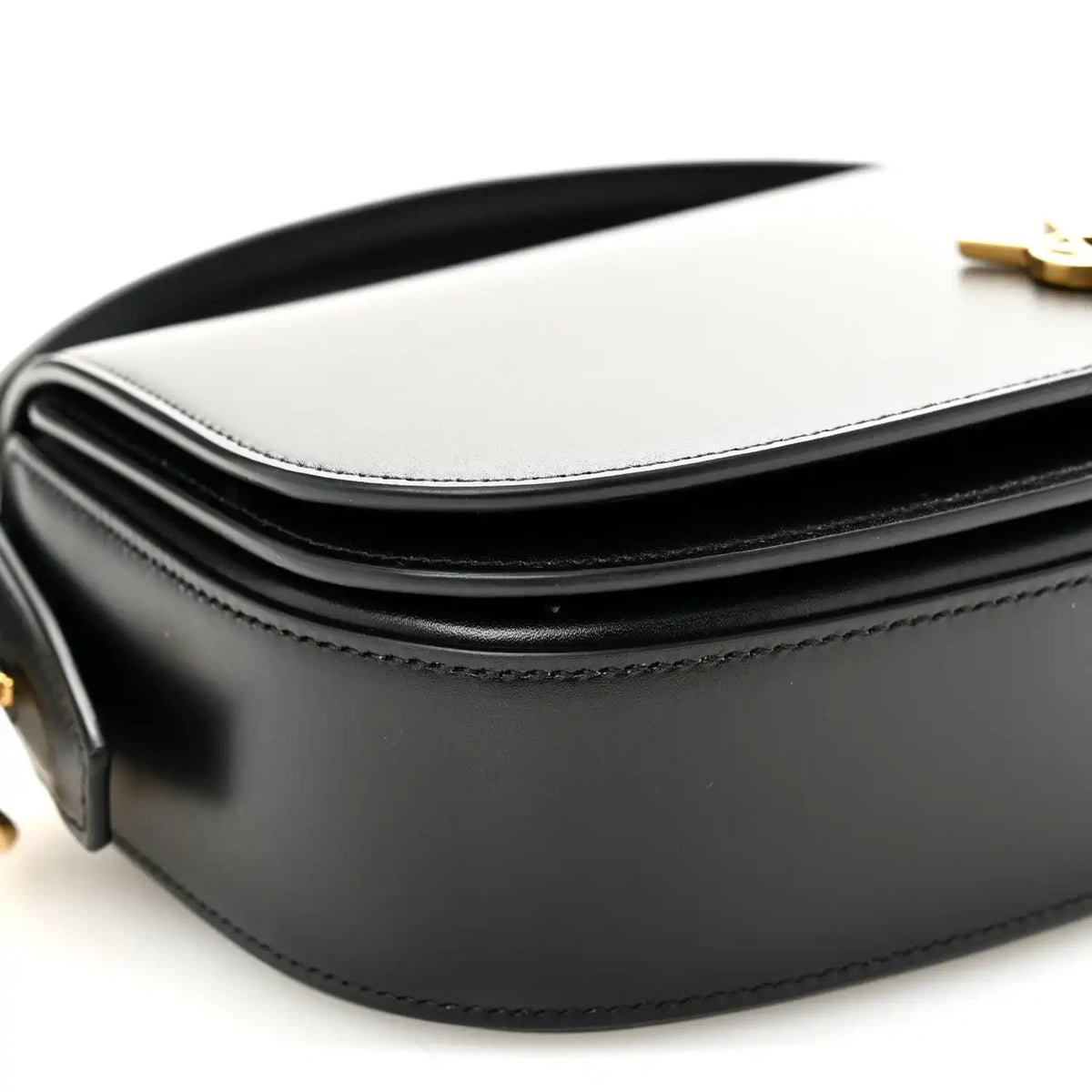 Bicolor leather crossbody bag detail with white flap, black body, and YSL clasp.