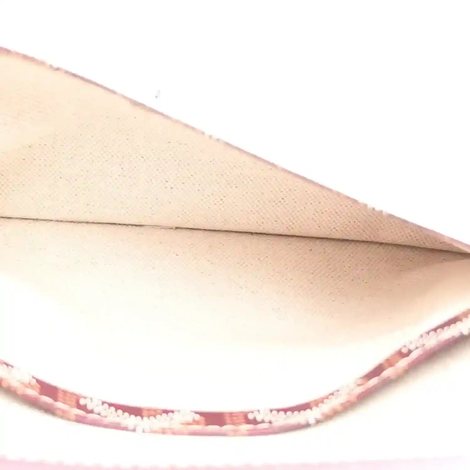 Light beige interior lining with burgundy trim inside hobo shoulder bag