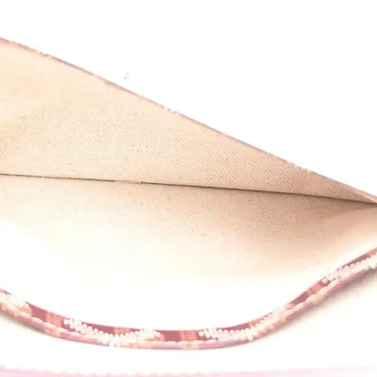 Light beige interior lining with burgundy trim inside hobo shoulder bag