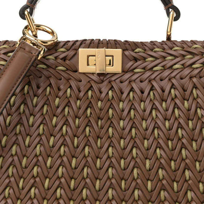Brown woven leather satchel with gold clasp and logo plate on top front